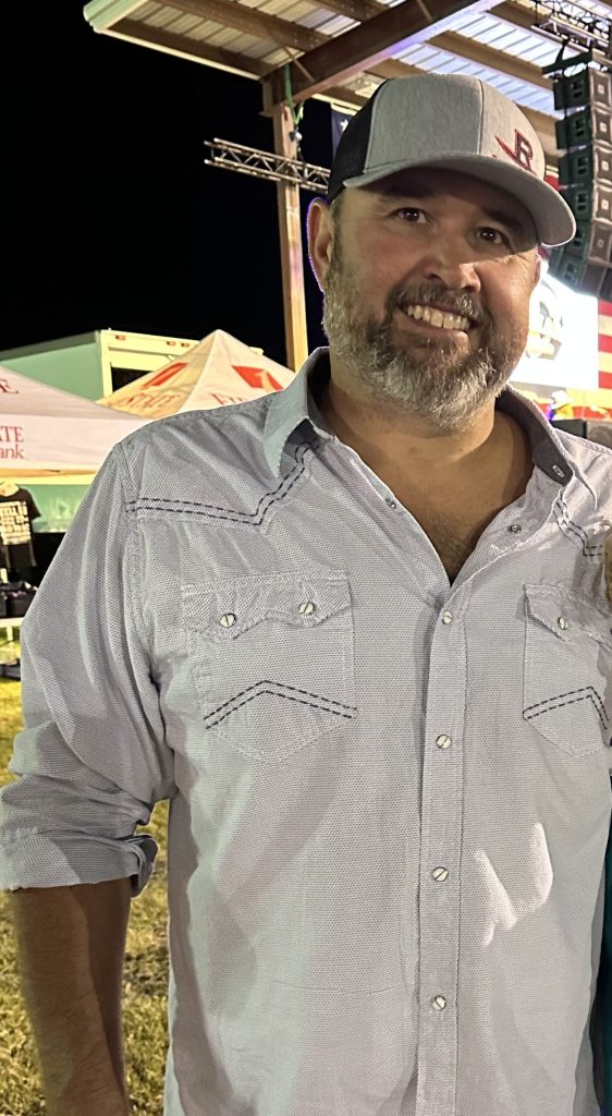 man wearing a baseball hat and a button up shirt